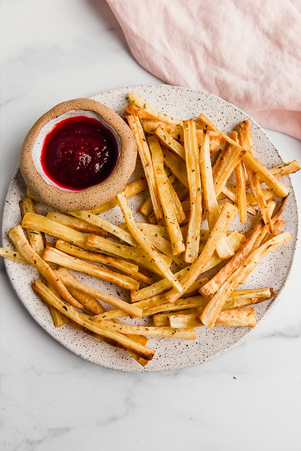 parsnip fries on plate with dipping sauce