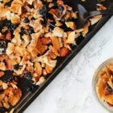 A sheet pan with homemade granola on it after baking.