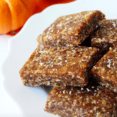 A stack of pumpkin energy bars piled on a white plate.