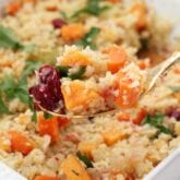 A container of paleo stuffing with a spoon taking a spoonful out.