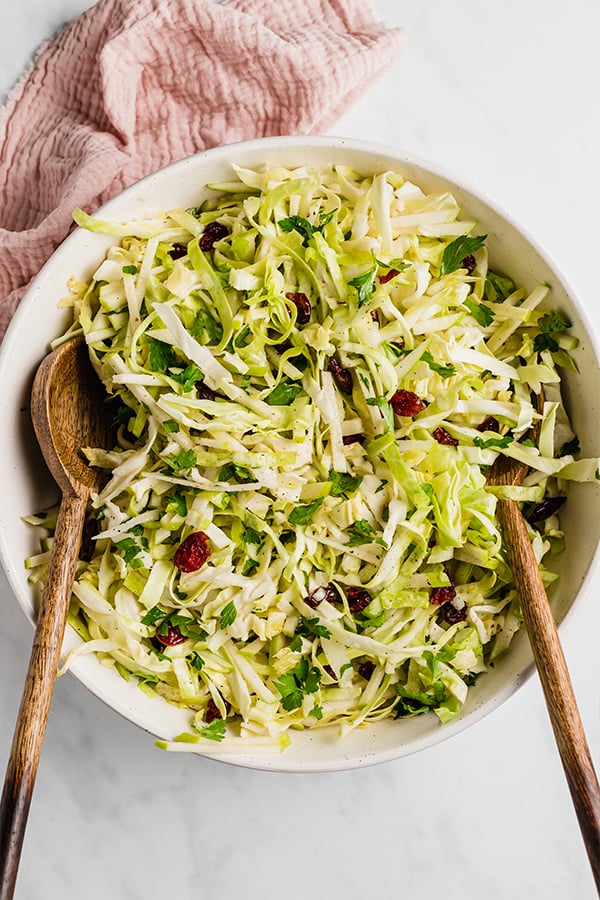 thanksgiving coleslaw in bowl with 2 spoons
