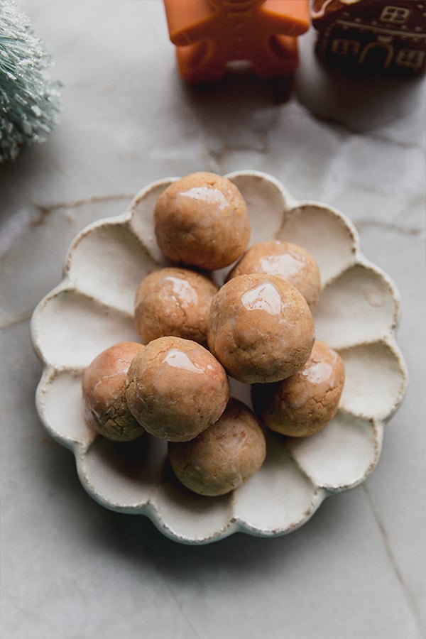 A serving plate filled with gingerbread donut holes.