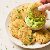 Guacamole and cauliflower veggie nuggets on a plate.