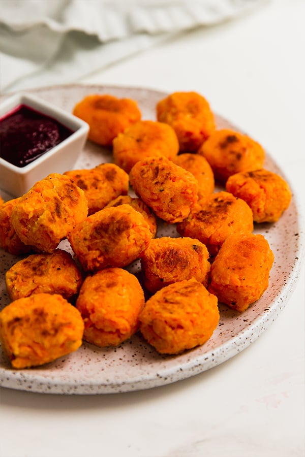 sweet potato tots on a plate with ketchup