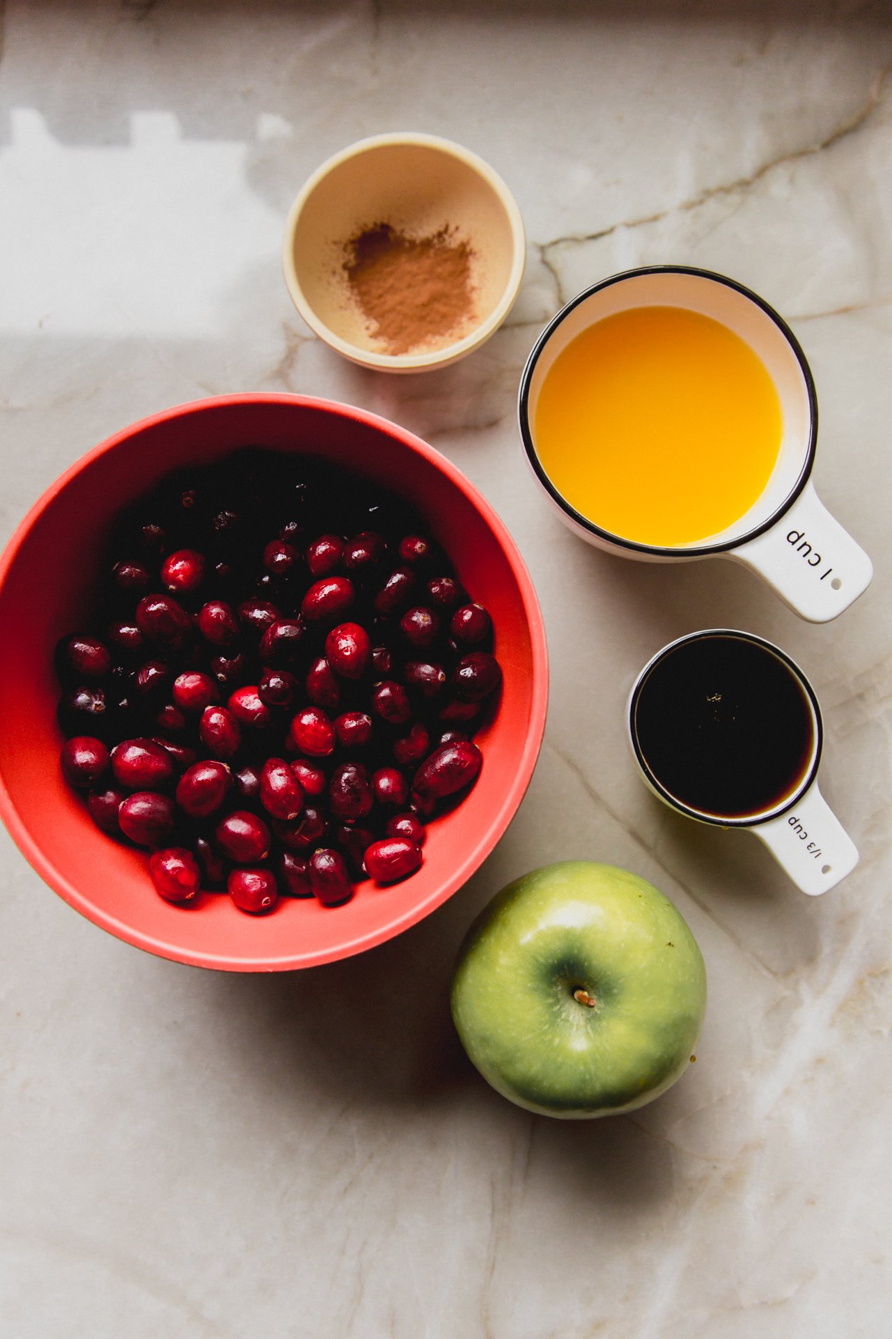 Apple cranberry sauce ingredients in separate bowls.