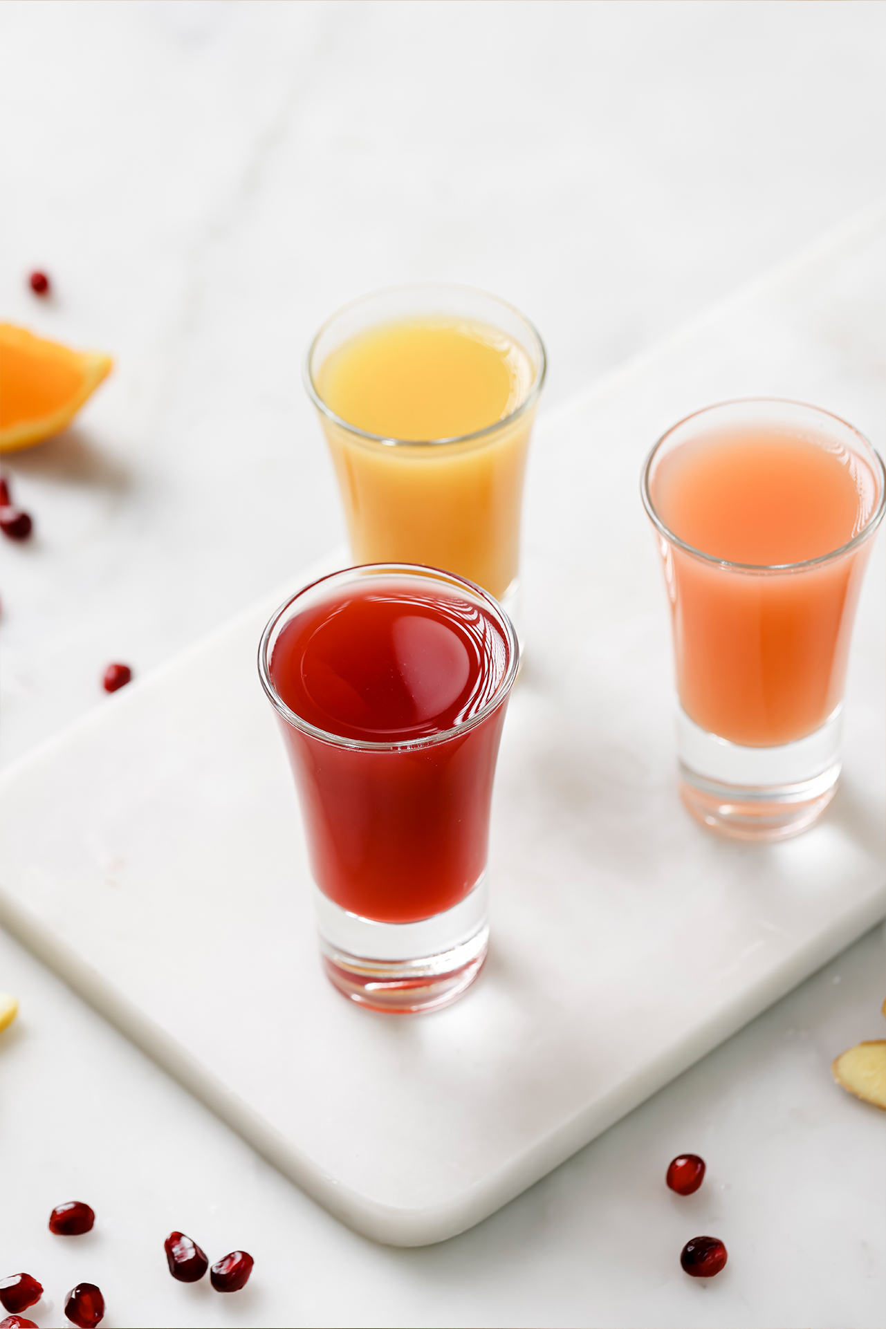 Three apple cider vinegar shots on a platter.