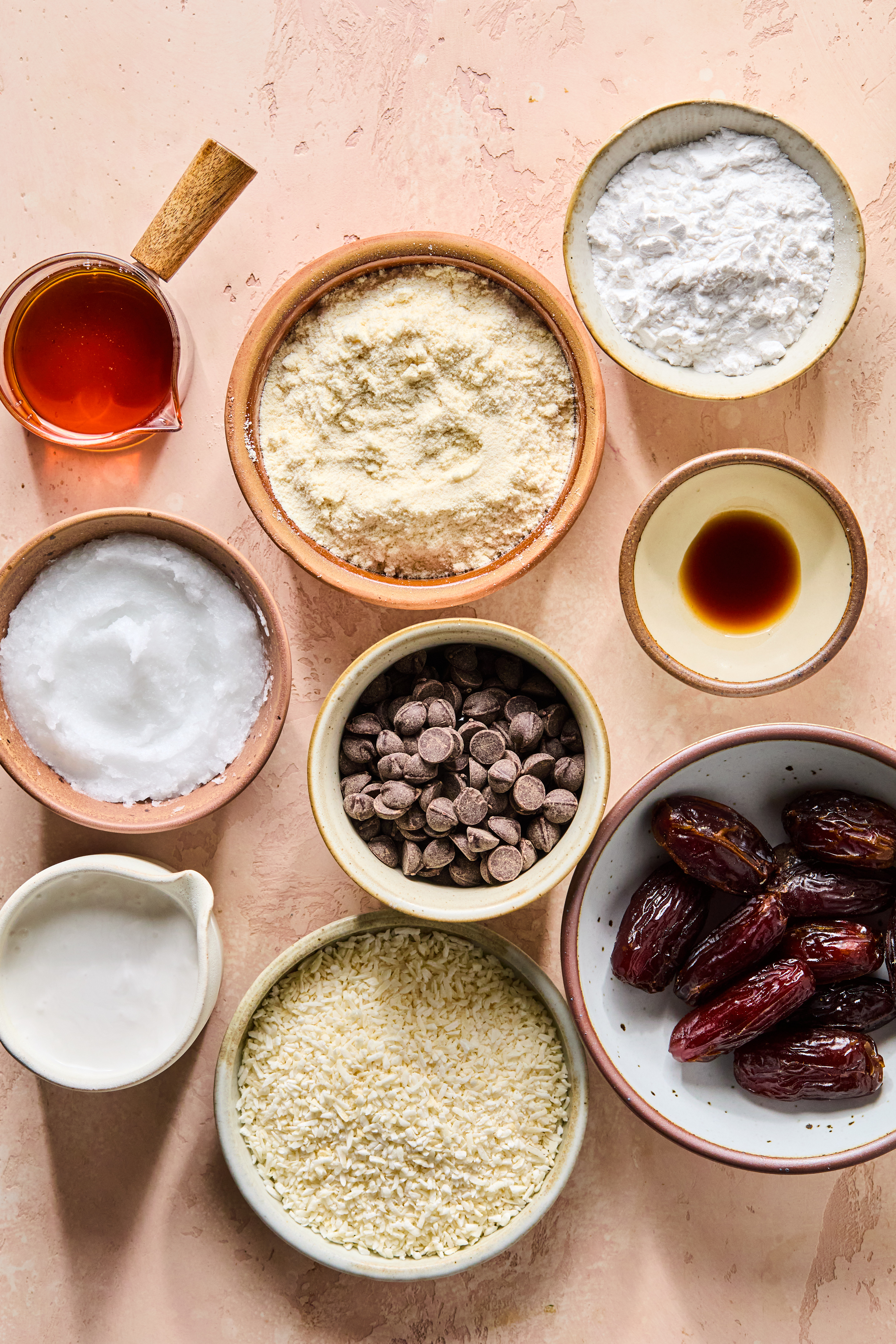 All the ingredients to make samoa cookies laid out in bowls on the counter before cooking begins.