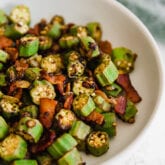 A white bowl filled with cooked okra.
