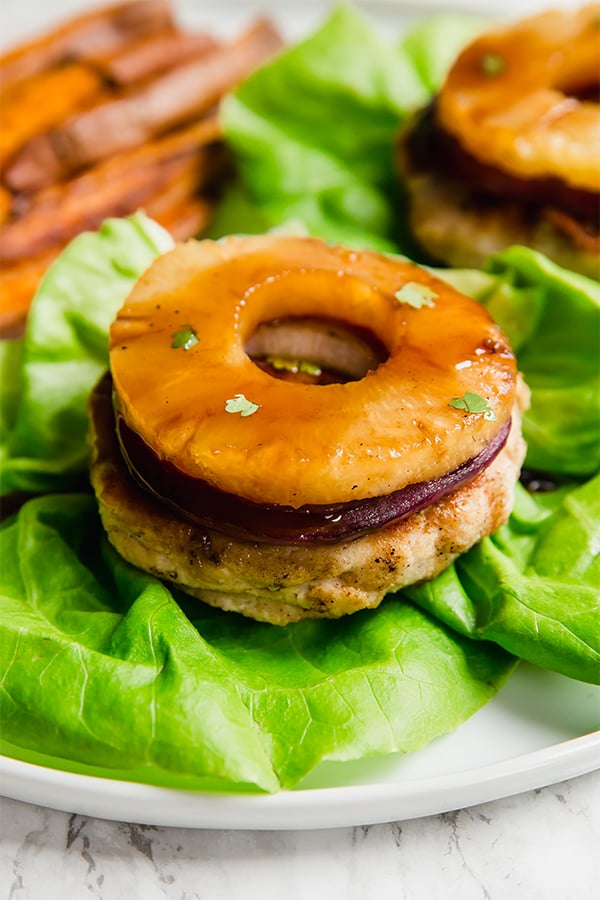These Hawaiian Teriyaki Chicken Burgers are next level decadent. With grilled pineapple and a yummy teriyaki sauce, they're perfect for a summer day. These burgers are healthier, paleo, whole30, and AIP.