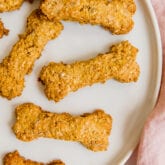A white plate filled with homemade peanut butter dog treats.