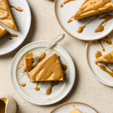 Several plates with slices of salted caramel pumpkin cheesecake.