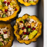 A baking dish with turkey stuffed acorn squashes after baking.
