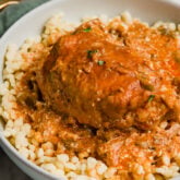 A white bowl with authentic chicken paprikash in it.