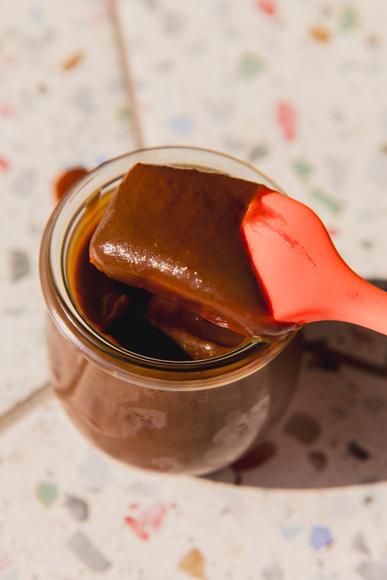 Nightshade free BBQ sauce with spatula dipping in the jar.