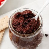 Edible brownie batter in a glass jar.