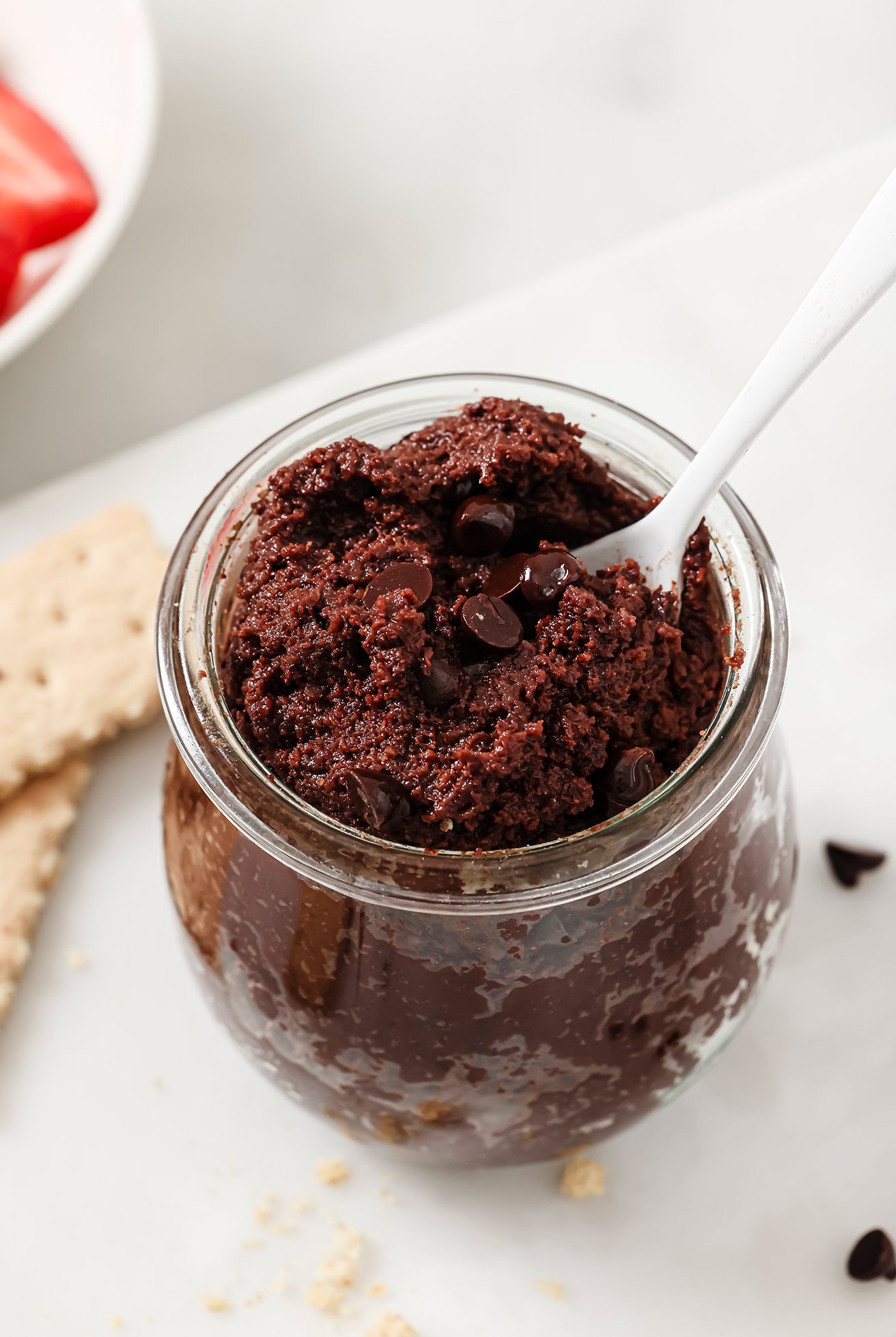 Edible brownie batter in a glass jar.