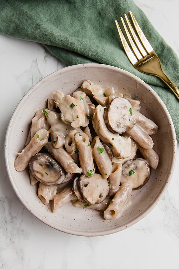 mushroom pasta in a bowl with a fork