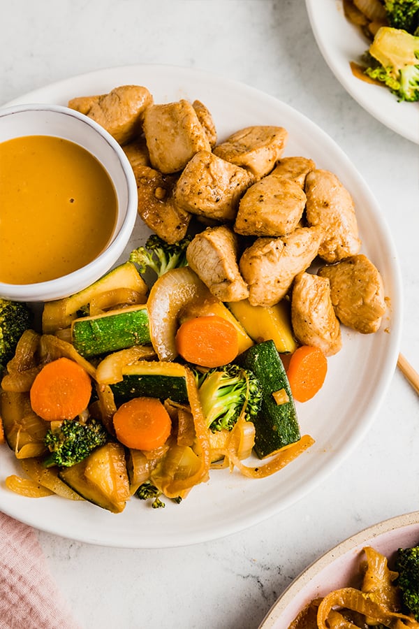 hibachi chicken with vegetables and mustard sauce on a plate
