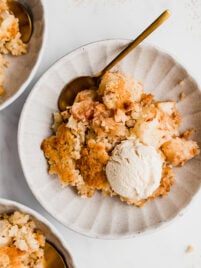 apple crisp on plate with spoon and ice cream