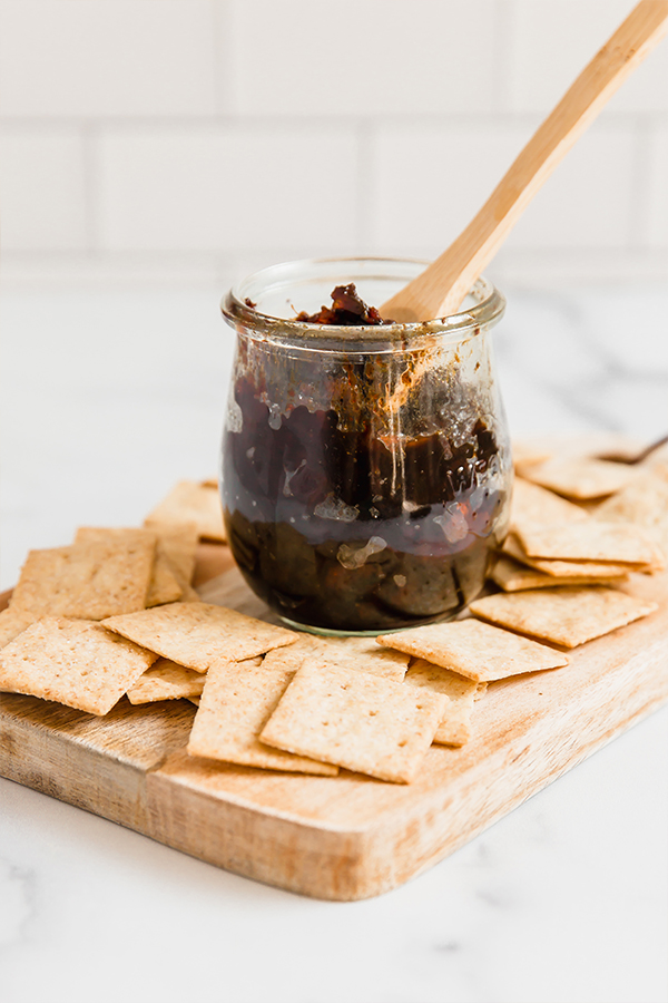 apple bacon jam in jar with spoon and crackers