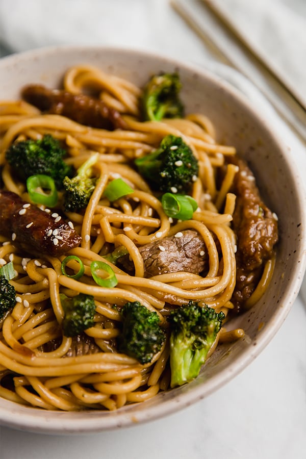 beef and broccoli lo mein in a bowl