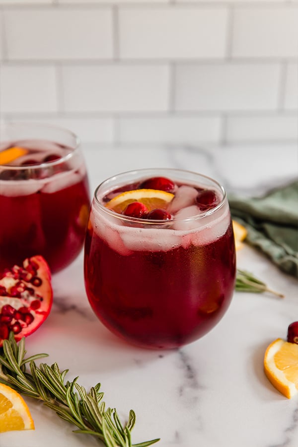 cranberry pomegranate holiday mocktail in wine glass