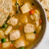 chicken pot pie soup in bowl with crackers