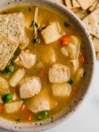 chicken pot pie soup in bowl with crackers