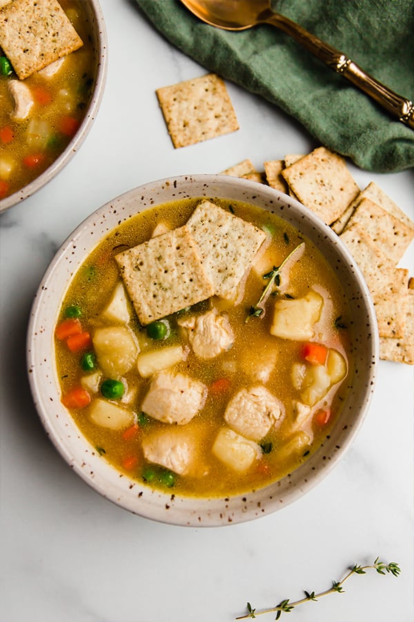 chicken pot pie soup in bowl with crackers