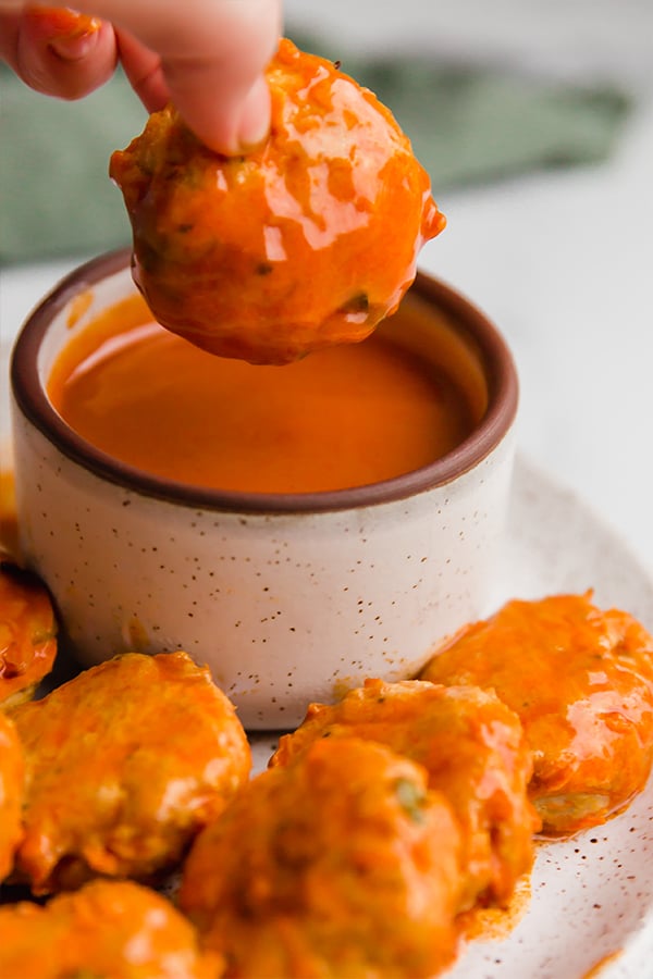 buffalo chicken poppers on plate with sauce