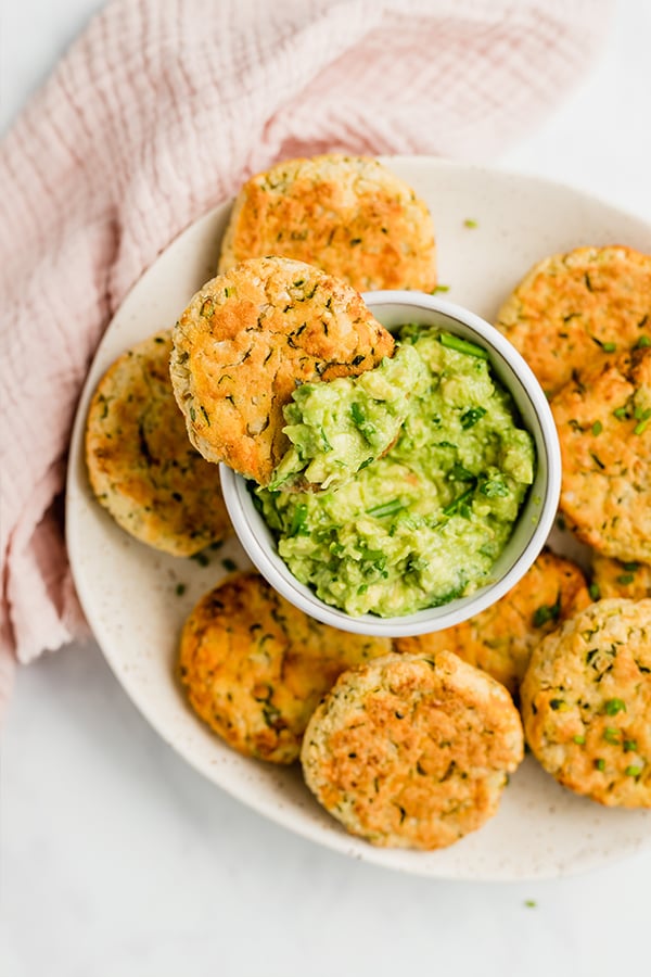 baked veggie nuggets on plate with guacamole and a bite out of one nugget