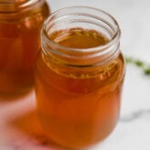 Glass jars of bone broth.