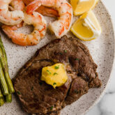 Steak and shrimp on a plate.
