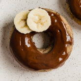 Banana slices on a banana bread donut.