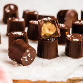 Several salted caramel cups, one of which is missing a bite.