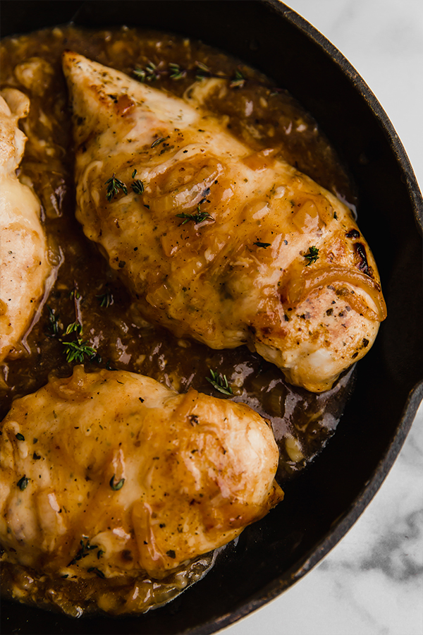 Close up of French onion chicken in cast iron skillet
