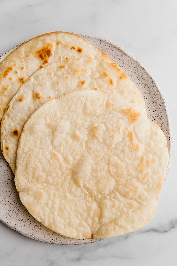 Tortillas crisped on a plate ready for assembly