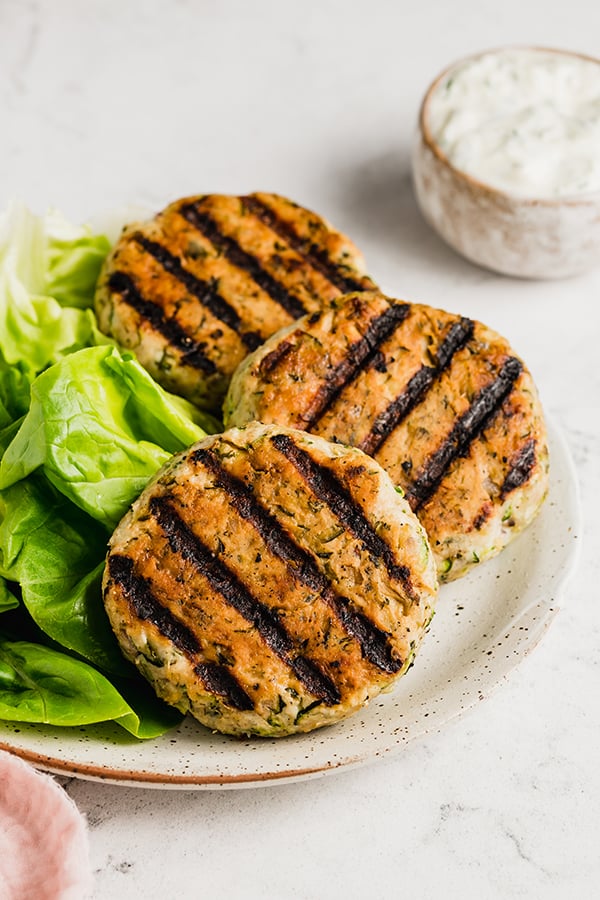 Grilled greek chicken burgers on a plate