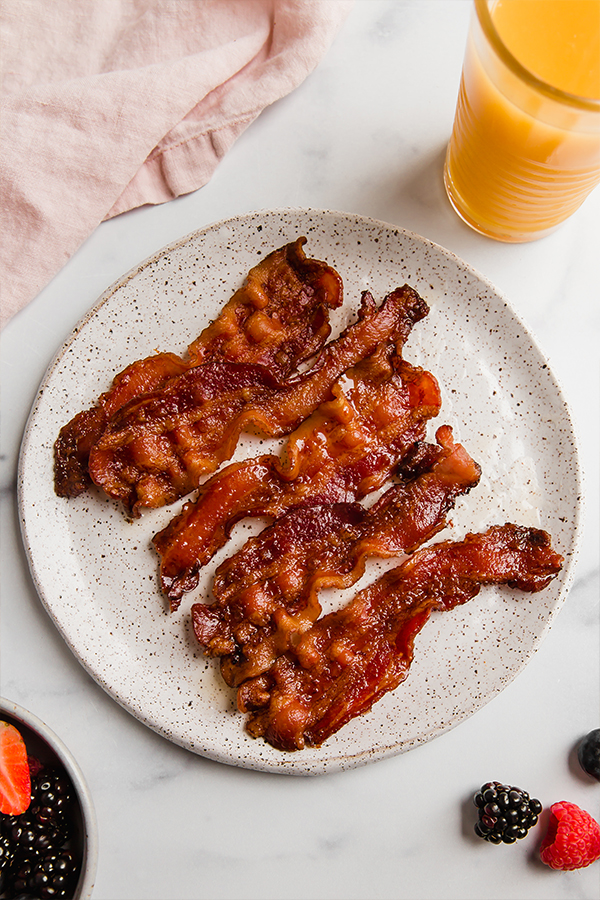 Top view of bacon slices cooked on a plate