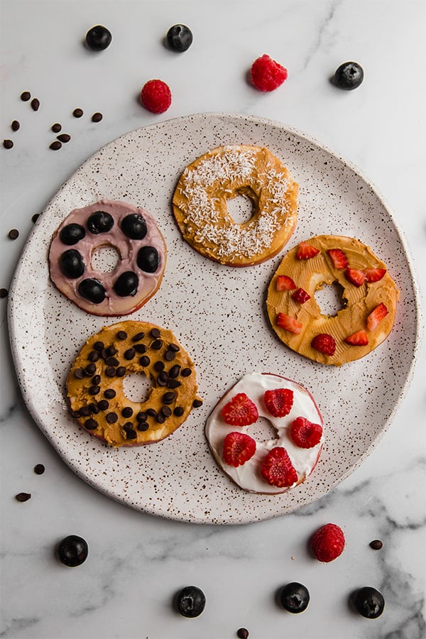 Apple "donuts" with toppings on plate