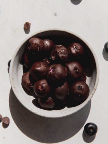 Chocolate yogurt frozen blueberries in a bowl.