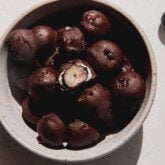 Chocolate blueberries in a bowl.