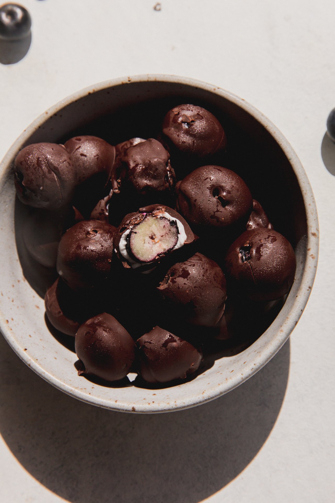 Chocolate blueberries in a bowl.
