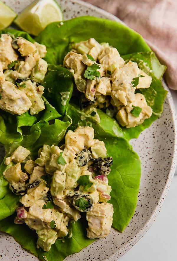 Yogurt curry chicken salad served on butter lettuce on a plate