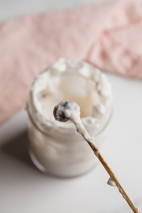 Blueberry on a tooth pick dipped in coconut yogurt