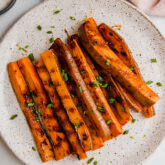 Grilled sweet potato fries piled on a plate.