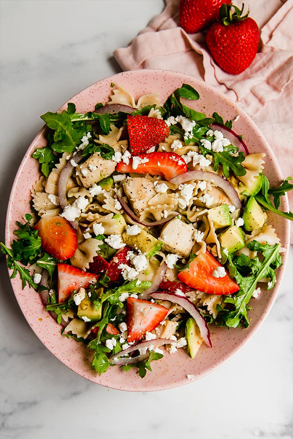 Strawberry balsamic pasta salad in pink bowl