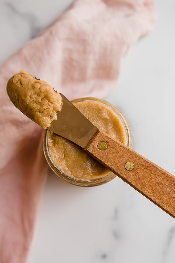 Jar of tigernut butter with knife ready to spread on food
