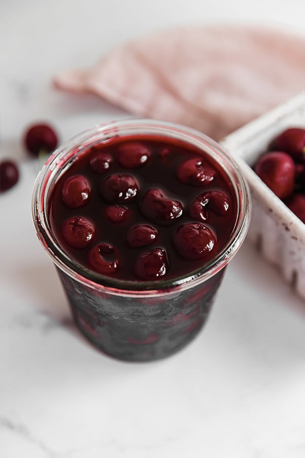 Homemade maraschino cherries in glass jar