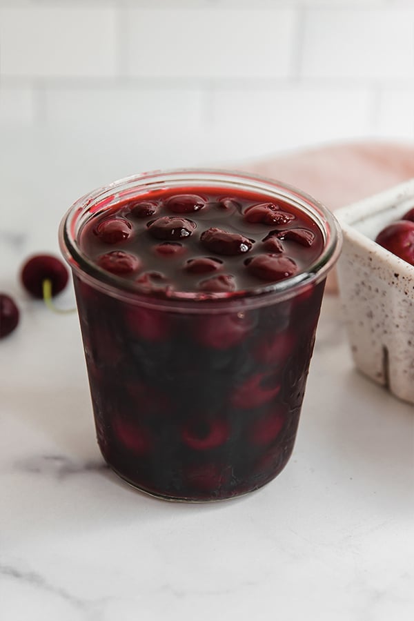 Homemade maraschino cherries in glass jar